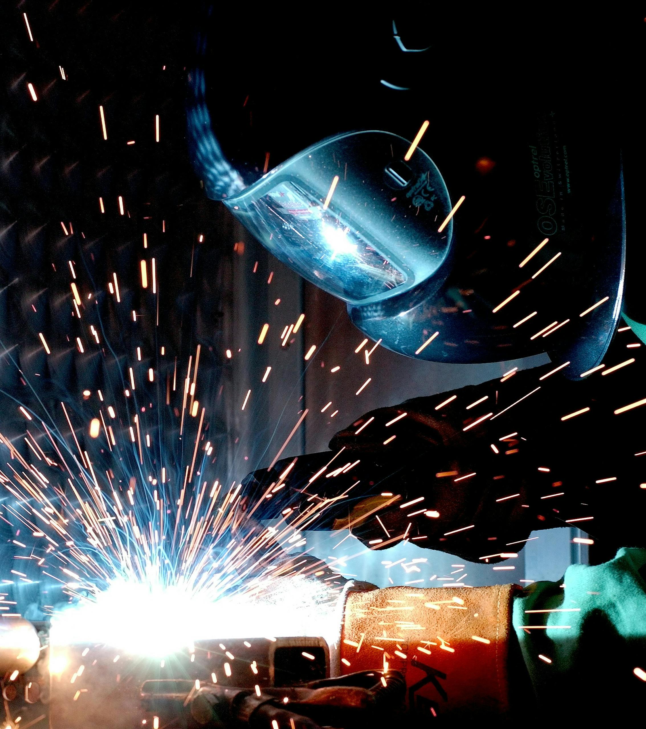 a focused welder works with metal in an industrial setting creating vibrant sparks. 73833 scaled, TAG: Employment and HR Solutions