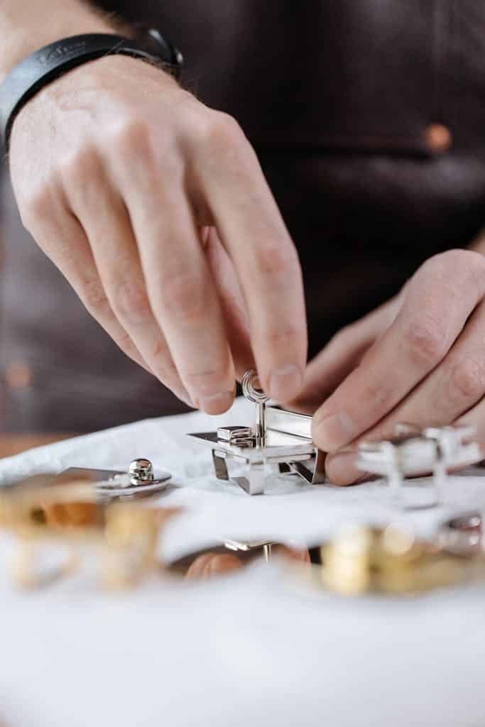 Close-up of hands assembling mechanical parts with precision tools. Ideal for industrial or mechanical themes.