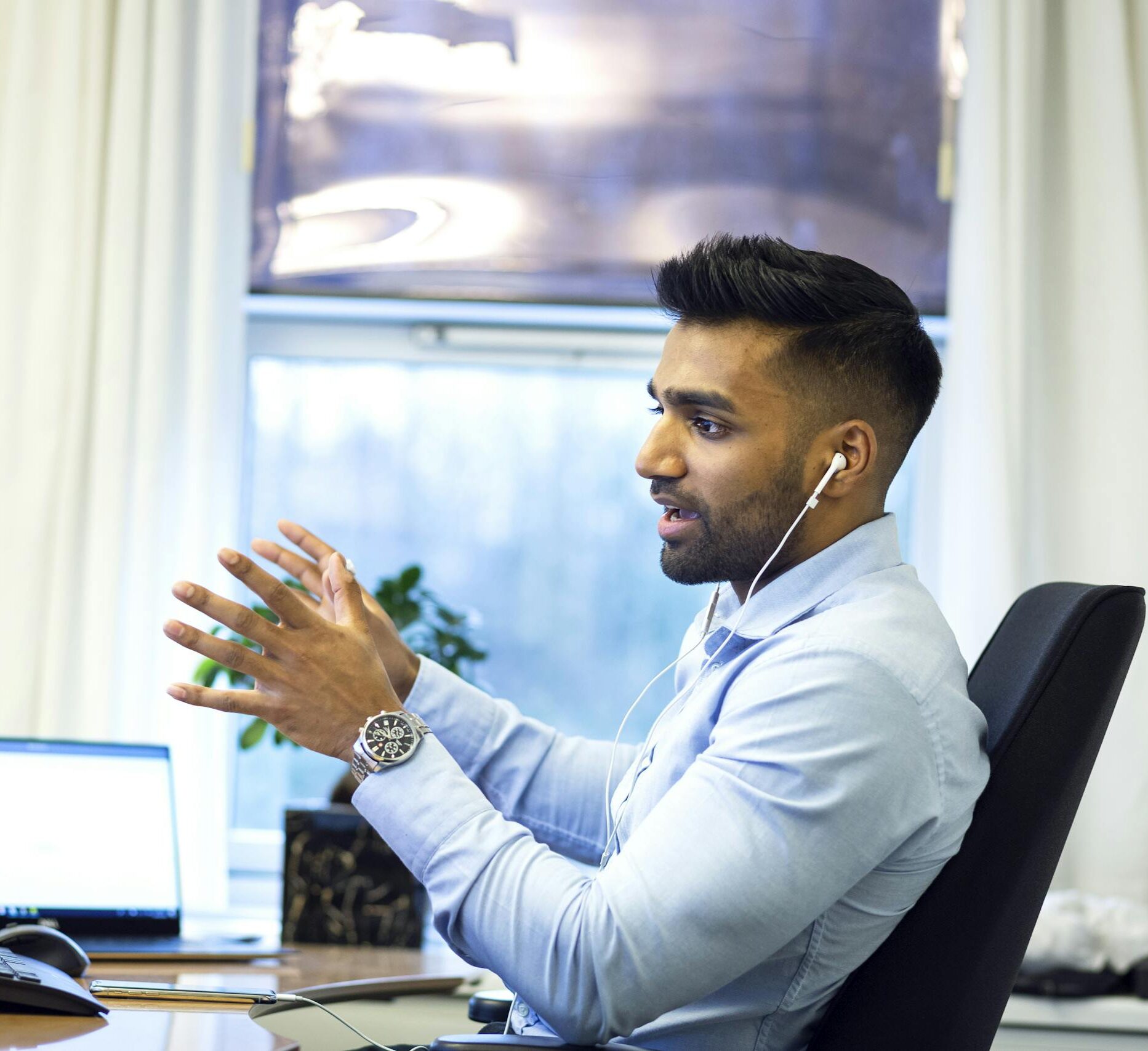 adult male engaged in a virtual meeting using earphones in an office setting. 2505026 scaled e1737658524162, Executive Search & Talent Acquisition