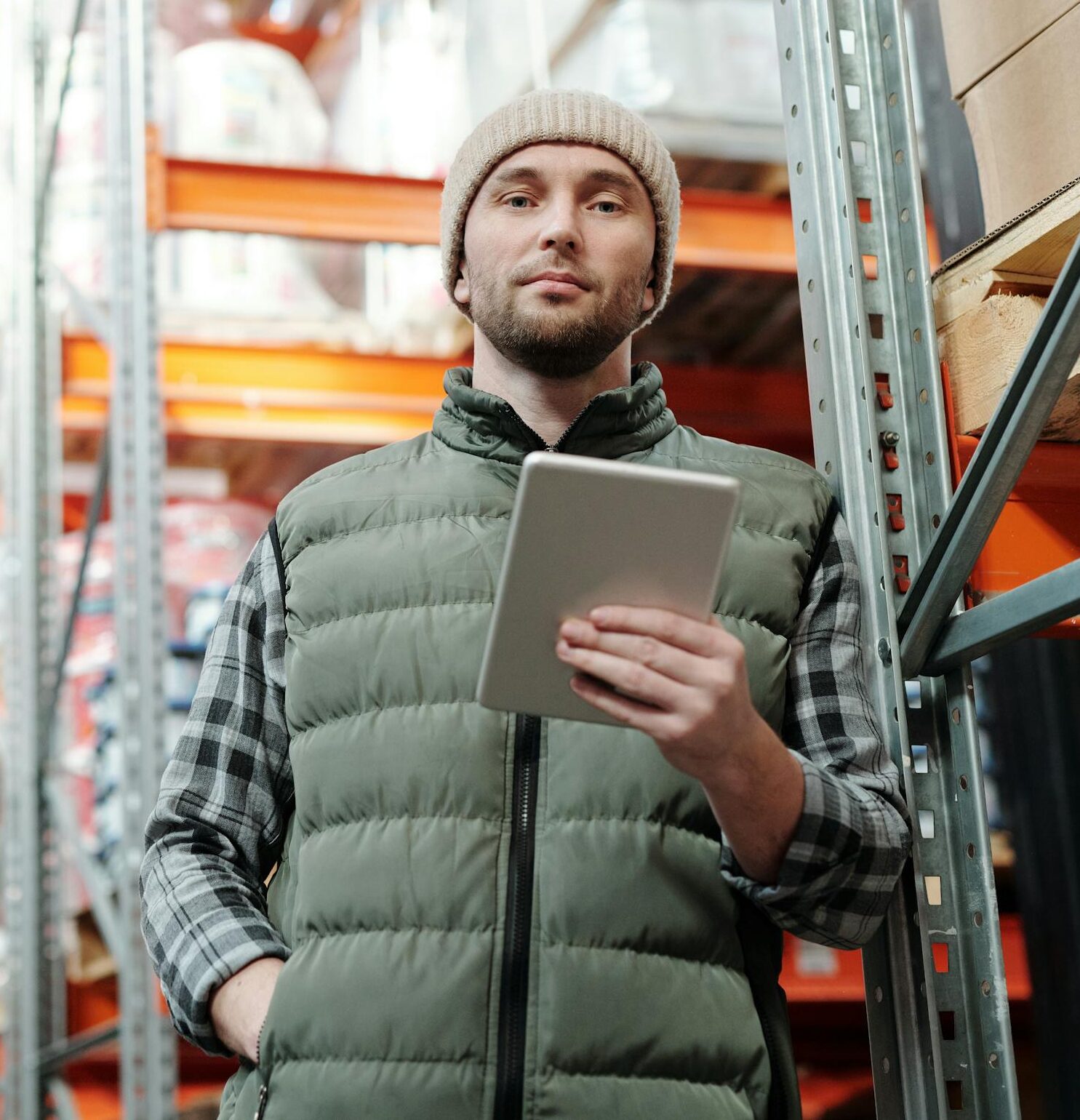 young male warehouse manager in a beanie holding a tablet in a storeroom. 4484075 scaled e1737659033770, TAG: Employment and HR Solutions