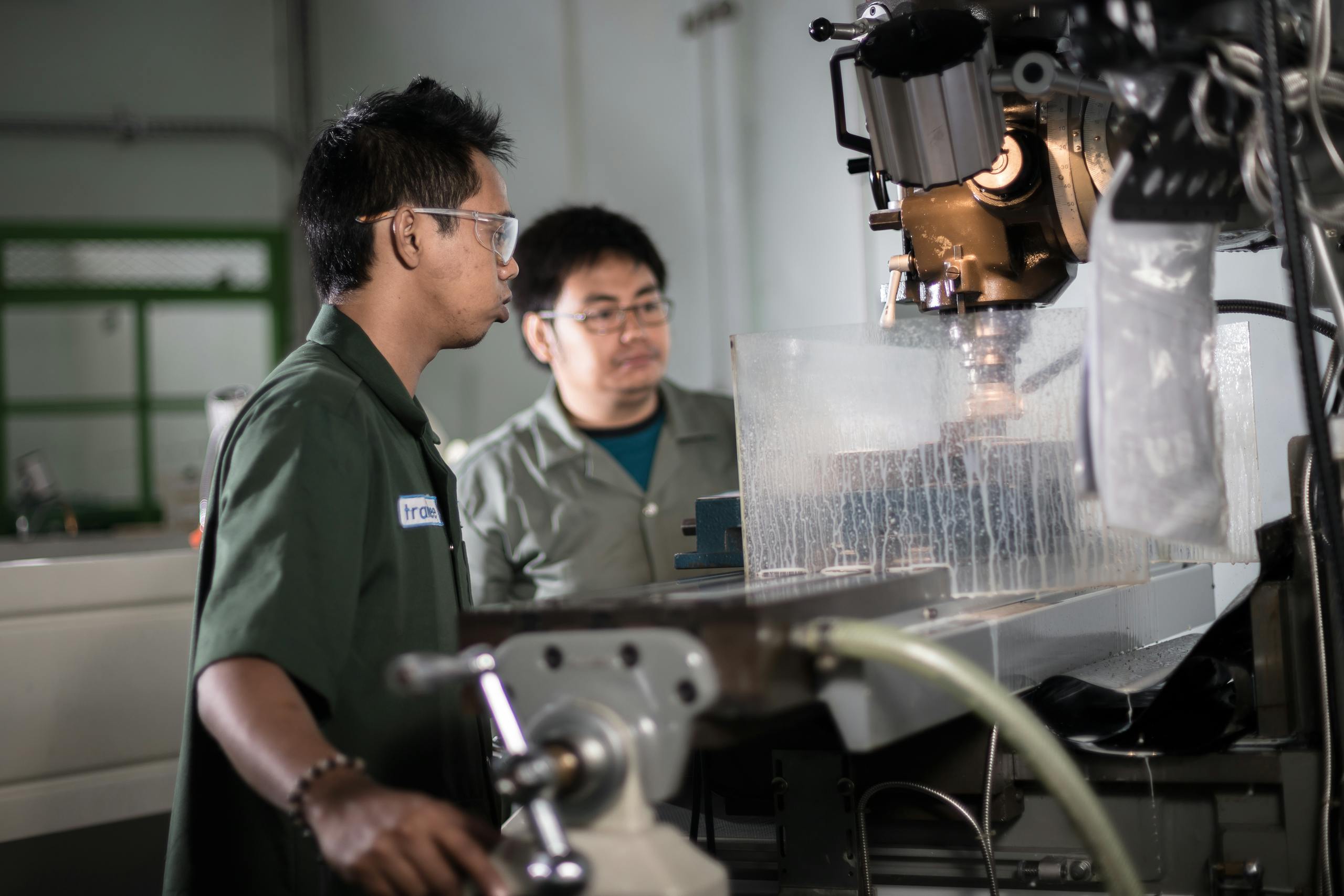 two technicians in a workshop in indonesia operating a cnc machine focused on precision engineering. 4281613 scaled, TAG: Employment and HR Solutions